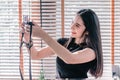 Beautiful girl sitting outdoors and taking selfie video for fashion blog. Woman holding compact camera in her hand ant taking Royalty Free Stock Photo