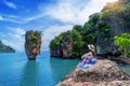 Beautiful girl sitting on the rock at James Bond island in Phang nga, Thailand. Royalty Free Stock Photo