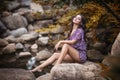 Beautiful girl sitting on stones