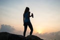 The beautiful girl sitting on stones and looking in a distance, the girl at sunset to meditate in silence, beautiful body. concept Royalty Free Stock Photo