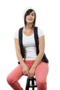 Beautiful girl sitting on a stool Royalty Free Stock Photo