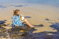Beautiful girl sitting on the tropical beach with huge big seashell, Mauritius island Royalty Free Stock Photo
