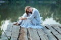 Beautiful girl sitting on the wharf bored. Royalty Free Stock Photo