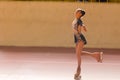 Beautiful teenage girl advances smiling during a roller skating routine