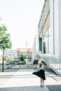 Beautiful girl in a skirt is dancing on the street in Berlin Royalty Free Stock Photo