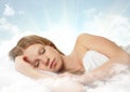 Beautiful girl sleeping on a cloud in the sky Royalty Free Stock Photo