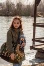 Beautiful girl with a small dog. girl on a walk with a dog and a doll. Girl playing doll. Portrait of a girl 9 years old Royalty Free Stock Photo