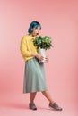 Beautiful girl smelling flowers while posing to the camera Royalty Free Stock Photo