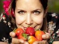 Beautiful girl smelling fresh strawberries in the spring Royalty Free Stock Photo
