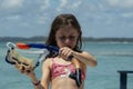 Beautiful girl with snorkel in her hands with sea in the background Royalty Free Stock Photo