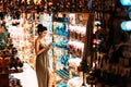 Beautiful girl in a souvenir shop in Turkey. Girl chooses a souvenir Oriental shop. Turkish Souvenirs. Oriental bazaar.