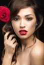 Beautiful girl in the Spanish way of Carmen with red lips and a rose in her hair. Royalty Free Stock Photo