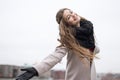 Beautiful girl spinning on the street Autumn quay overcast. Girl in a black coat, a scarf and a red dress against a gray sky. Not Royalty Free Stock Photo