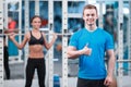 Beautiful girl in sports club with instructor Royalty Free Stock Photo