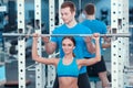 Beautiful girl in sports club with instructor Royalty Free Stock Photo