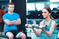 Beautiful girl in sports club with instructor Royalty Free Stock Photo