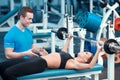 Beautiful girl in sports club with instructor Royalty Free Stock Photo