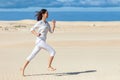 Beautiful girl in sportswear running in desert