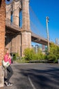 Beautiful girl standing in the Brooklyn Bridge park with a Brooklyn Bridge Royalty Free Stock Photo