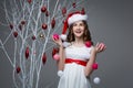 Beautiful girl standing near tree with christmas decorations Royalty Free Stock Photo