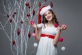 Beautiful girl standing near tree with christmas decorations Royalty Free Stock Photo