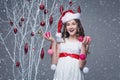 Beautiful girl standing near tree with christmas decorations Royalty Free Stock Photo