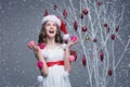 Beautiful girl standing near tree with christmas decorations Royalty Free Stock Photo