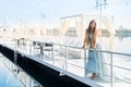 Beautiful girl standing on a pier in amazing mint dress Royalty Free Stock Photo