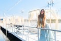 Beautiful girl standing on a pier in amazing mint dress Royalty Free Stock Photo