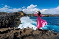 Beautiful girl standing on the rock at Angel`s Billabong near Broken beach in Nusa penida island, Bali in Indonesia. Royalty Free Stock Photo