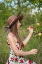 Beautiful girl stands on the apple garden