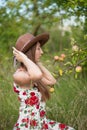 Beautiful girl stands on the apple garden
