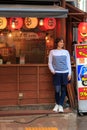 Beautiful girl stands near a Japanese restaurant in Tokyo