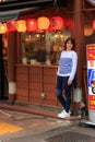 Beautiful girl stands near a Japanese restaurant in Tokyo