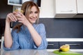 Beautiful girl starts her morning with a glass of water with lemon Royalty Free Stock Photo