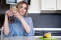 Beautiful girl starts her morning with a glass of water with lemon Royalty Free Stock Photo