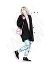 Beautiful girl in a stylish coat, jeans and shoes. Vector illustration for a postcard or a poster. Fashion and style. Royalty Free Stock Photo