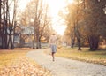 Beautiful girl with a suitcase in a park