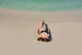 Beautiful girl sunbathes on a beach alone Royalty Free Stock Photo