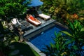 Beautiful girl sunbathing by the pool. A woman is lying on a sunbed by the pool.