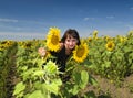 Beautiful girl between sunflower Royalty Free Stock Photo