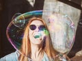 Beautiful girl in sunglasses and a big soap bubble near her face Royalty Free Stock Photo