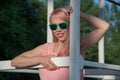 Beautiful girl in sunglasses and pink dress posing for a summer Royalty Free Stock Photo