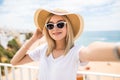 Beautiful woman in sunglasses and summer hat taking selfie on beach Royalty Free Stock Photo