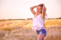 Beautiful girl at sunrise in a wheat field. Royalty Free Stock Photo