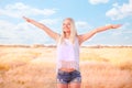 Beautiful girl at sunrise in a wheat field.