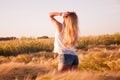 Beautiful girl at sunrise in a wheat field. Royalty Free Stock Photo