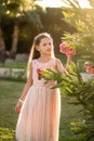 Beautiful girl at sunset in flowers. Royalty Free Stock Photo