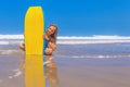 Beautiful girl with surf board on sea beach with waves Royalty Free Stock Photo