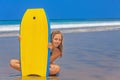 Beautiful girl with surf board on sea beach with waves Royalty Free Stock Photo